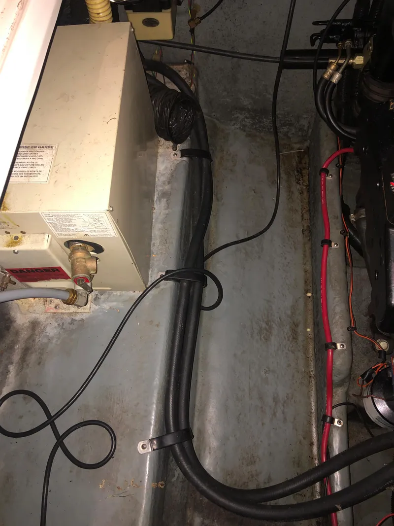 Slide: The Image of Engine compartment of a 1991 Sea Ray 250 Weekender boat, showing wiring and components. - 21