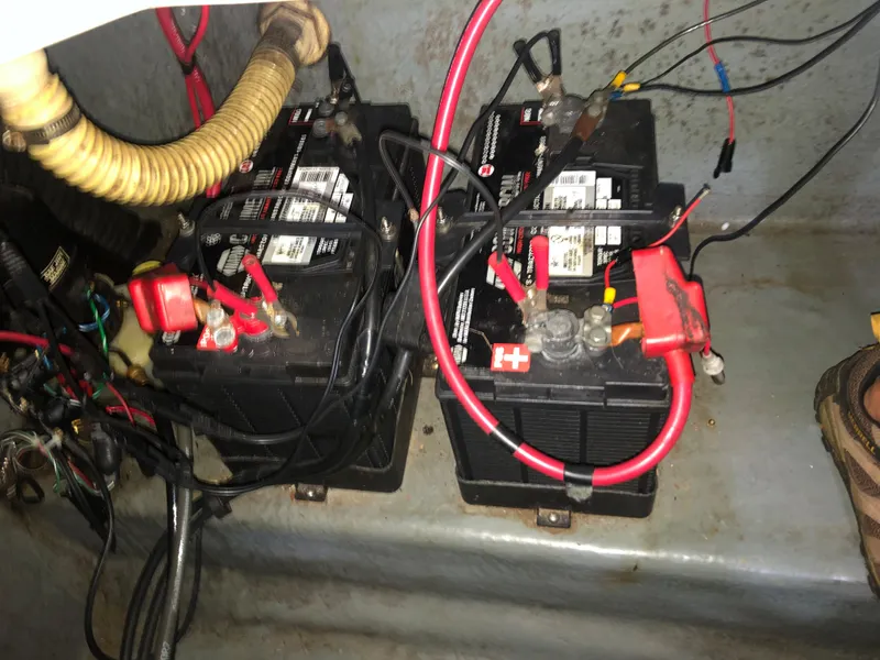 Slide: The Image of Batteries in a 1991 Sea Ray 250 Weekender boat with connected cables. - 25