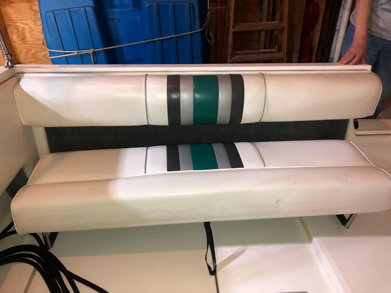 Slide: The Image of 1991 Sea Ray 250 Weekender boat seat with white, green, and gray upholstery. - 29