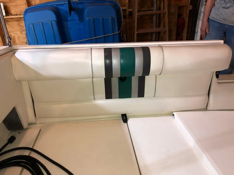 Slide: The Image of 1991 Sea Ray 250 Weekender boat interior with white and striped upholstery. - 30