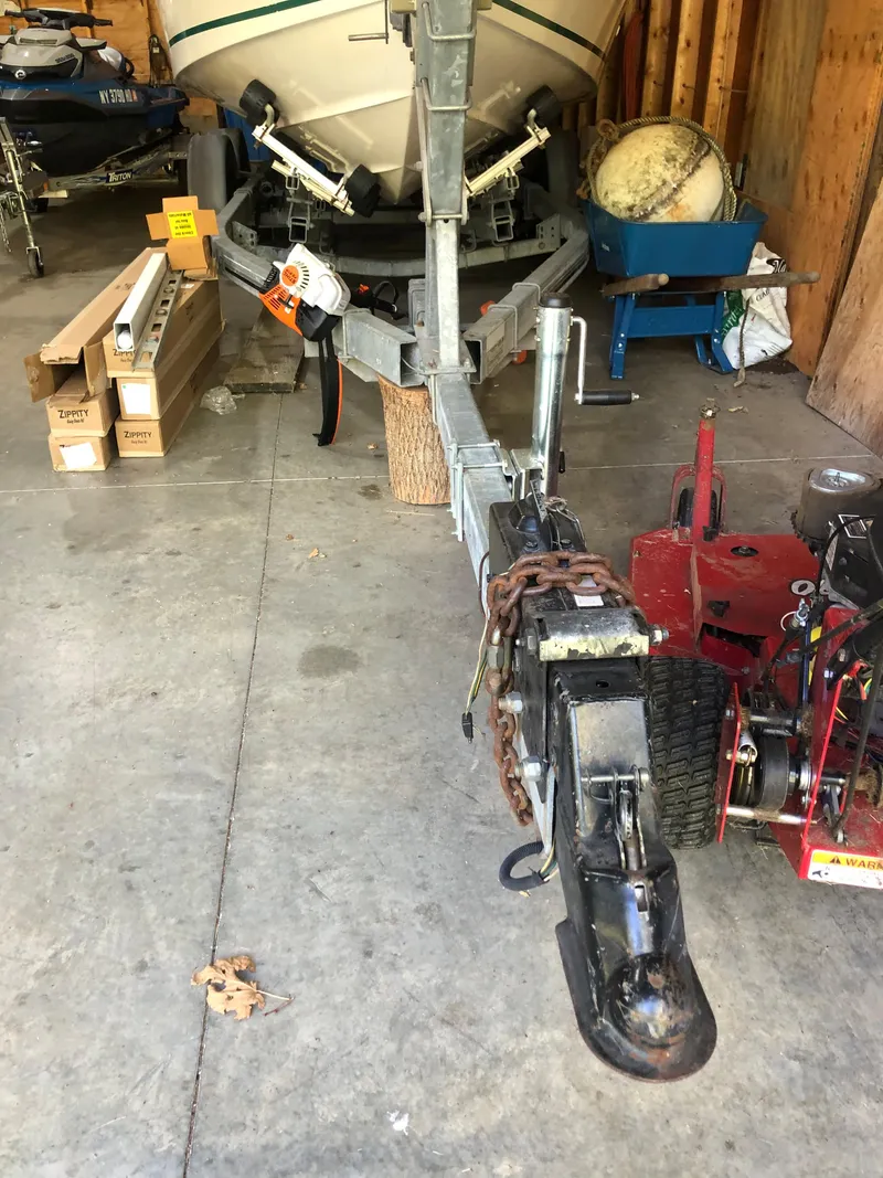 Slide: The Image of 1991 Sea Ray 250 Weekender boat on trailer in garage with equipment. - 6