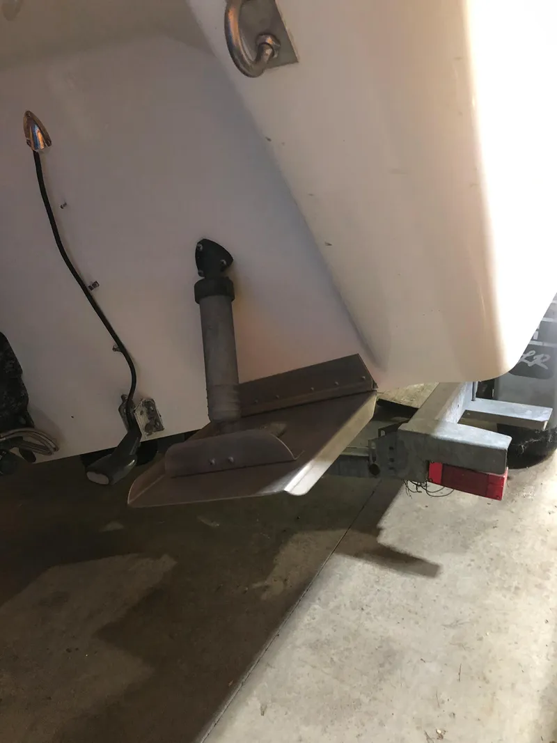 Slide: The Image of 1991 Sea Ray 250 Weekender boat on trailer, showing stern and propeller area. - 9