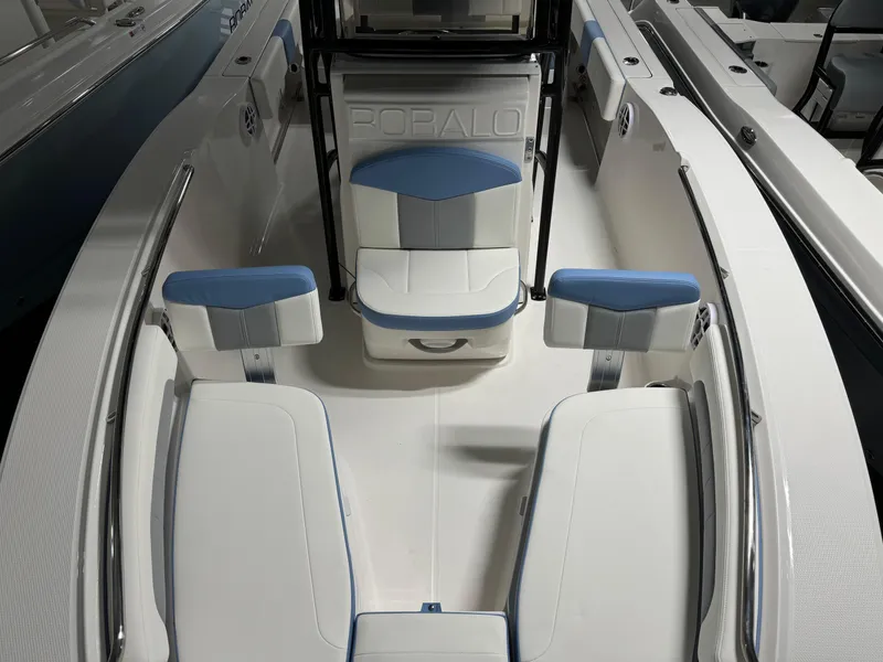 Slide: The Image of 2025 Robalo R202 Explorer boat interior with white and blue seating arrangement. - 15
