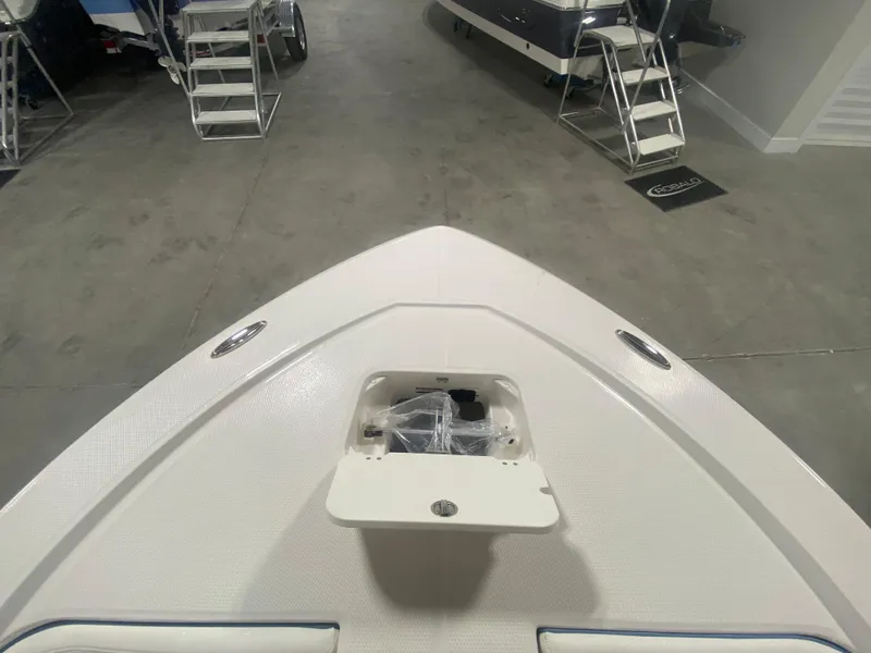 Slide: The Image of 2024 Robalo 206 Cayman boat bow with storage compartment in showroom. - 20