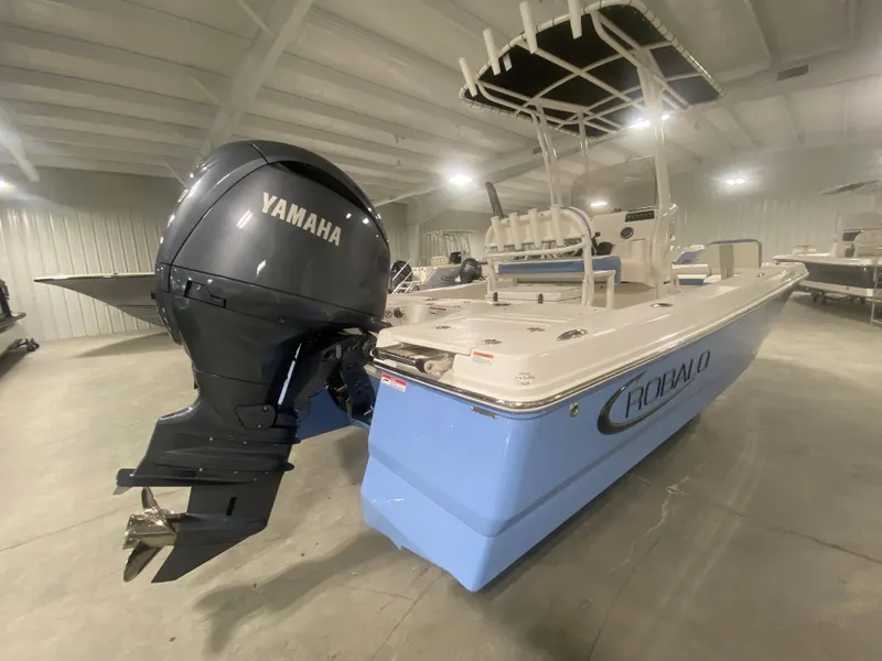 Slide: The Image of 2024 Robalo 206 Cayman boat with Yamaha outboard motor in a showroom. - 4