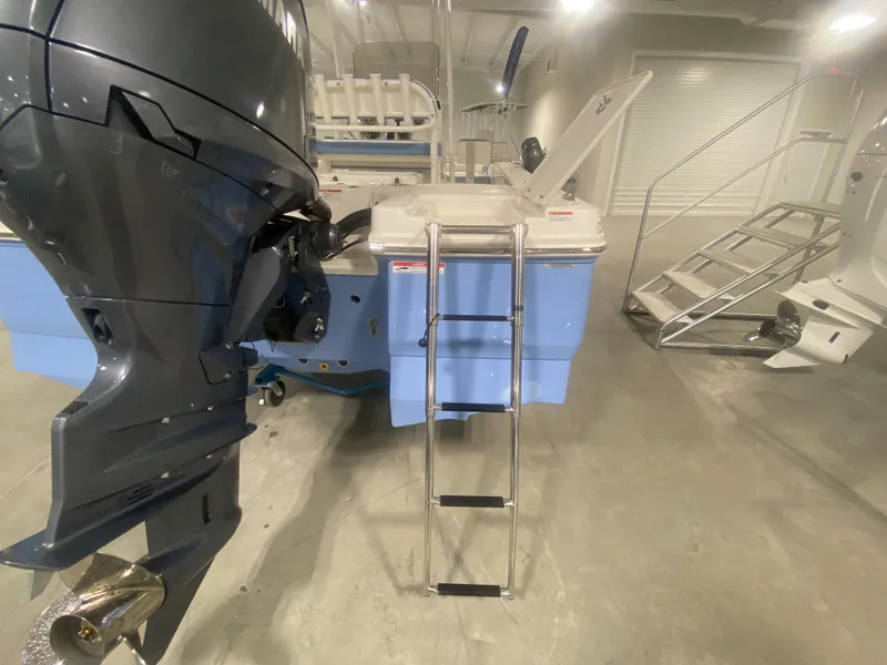 Slide: The Image of 2024 Robalo 206 Cayman boat with outboard motor and boarding ladder. - 6
