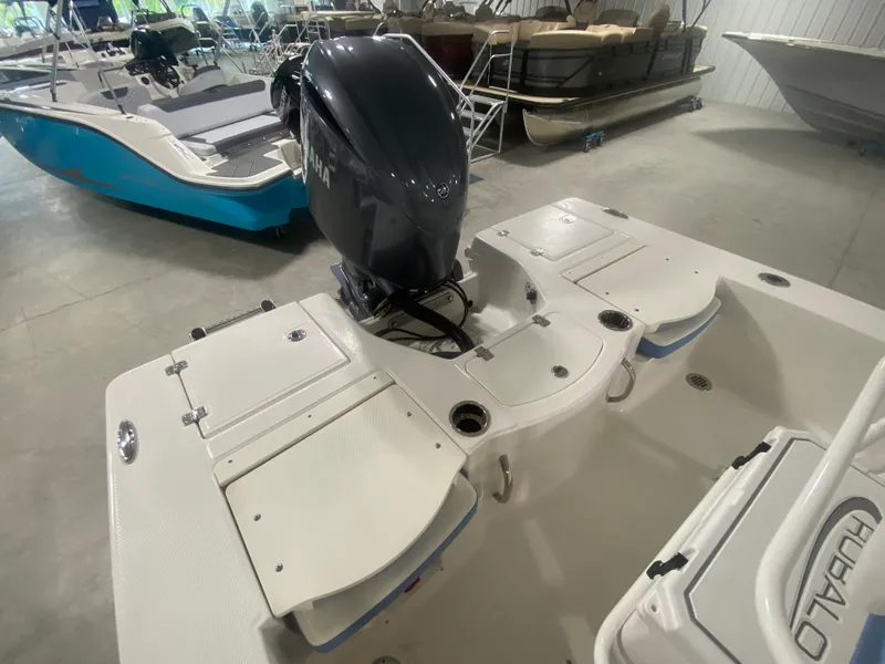 Slide: The Image of 2024 Robalo 206 Cayman boat interior with outboard motor in showroom. - 8