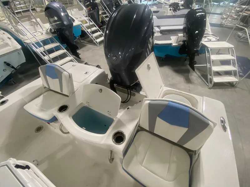 Slide: The Image of 2024 Robalo 206 Cayman boat interior with seating and outboard motor. - 9