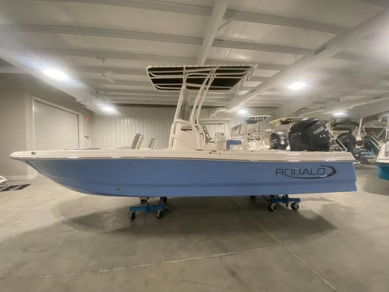 Slide: The Image of 2024 Robalo 206 Cayman boat in showroom, side view. - 0