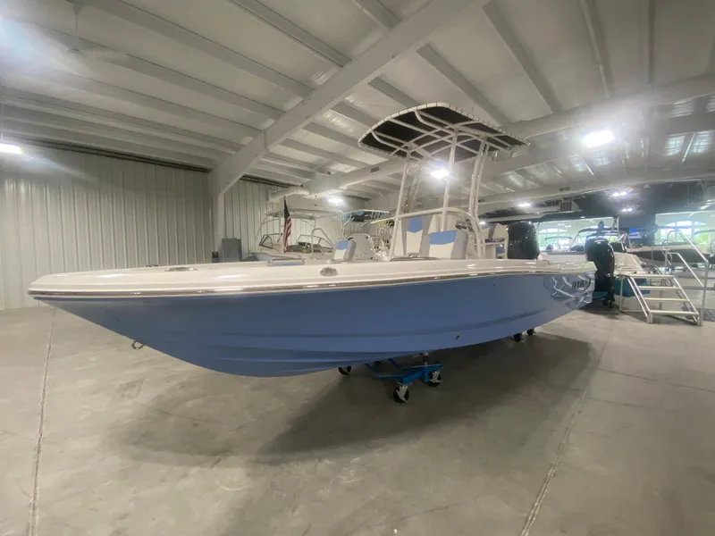 Slide: The Image of 2024 Robalo 206 Cayman boat in showroom. - 1