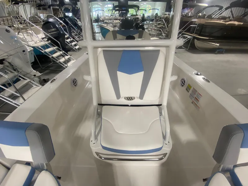 Slide: The Image of 2024 Robalo 206 Cayman boat interior with blue and white seating. - 13