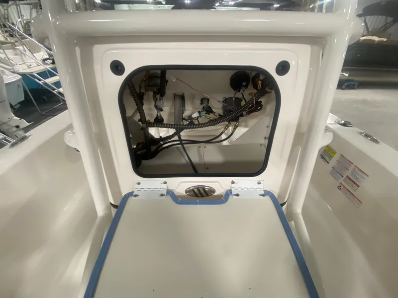 Slide: The Image of 2024 Robalo 206 Cayman boat interior wiring and storage compartment. - 17