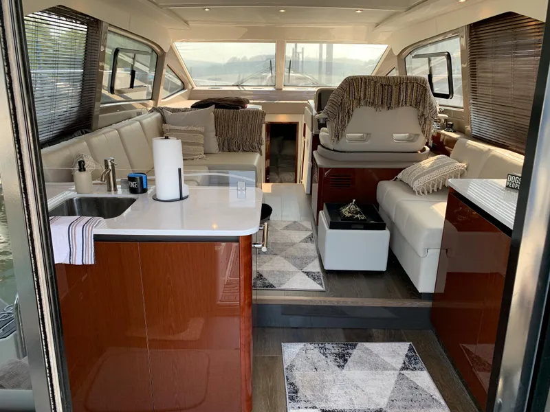 Slide: The Image of Interior of 2017 Sea Ray Sundancer 460 yacht with modern furnishings and panoramic windows. - 12