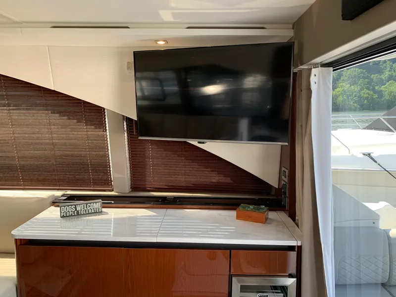 Slide: The Image of Interior of 2017 Sea Ray Sundancer 460 with TV and countertop. - 16