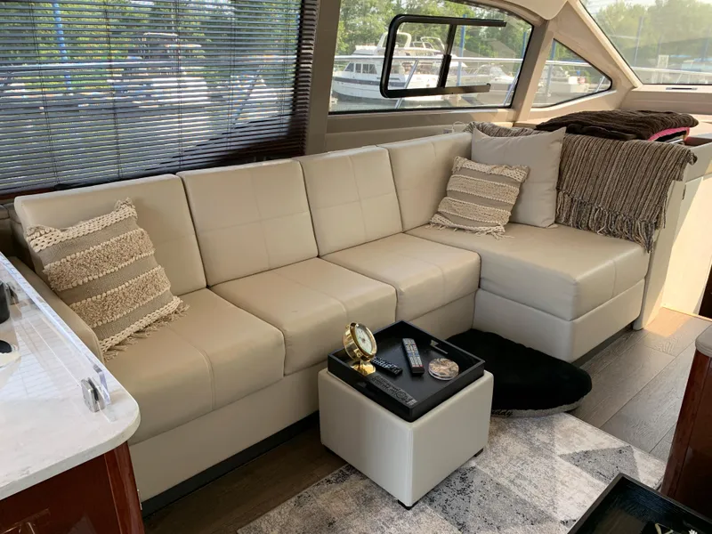 Slide: The Image of Luxurious interior of 2017 Sea Ray Sundancer 460 with beige leather sofa and modern decor. - 18