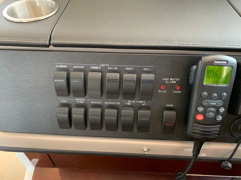 Slide: The Image of Control panel of a 2017 Sea Ray Sundancer 460 yacht with various switches and a radio. - 22