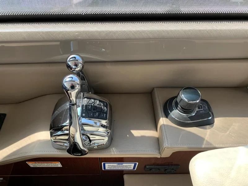 Slide: The Image of 2017 Sea Ray Sundancer 460 helm controls and joystick. - 24