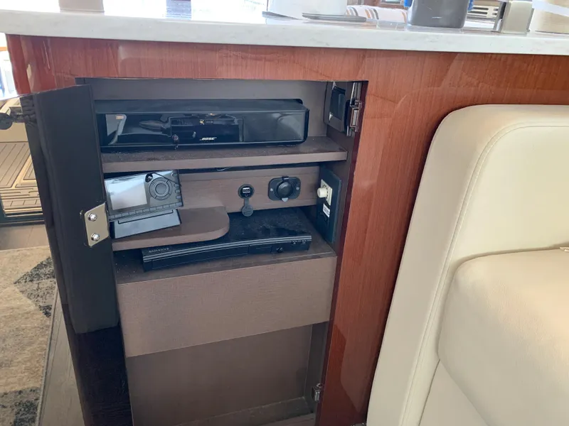 Slide: The Image of Cabinet interior of 2017 Sea Ray Sundancer 460 with electronic equipment. - 25