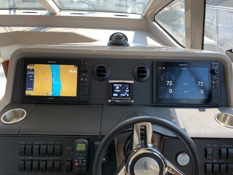 Slide: The Image of 2017 Sea Ray Sundancer 460 helm with navigation and control displays. - 28
