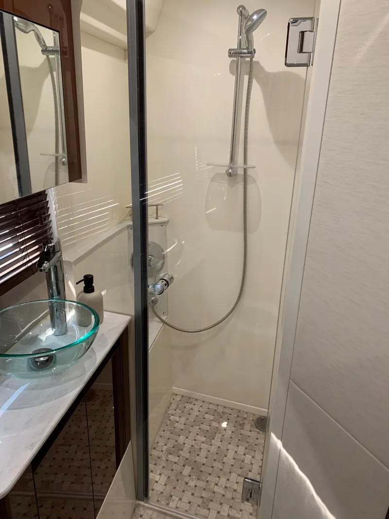 Slide: The Image of 2017 Sea Ray Sundancer 460 bathroom with glass shower and modern sink. - 40