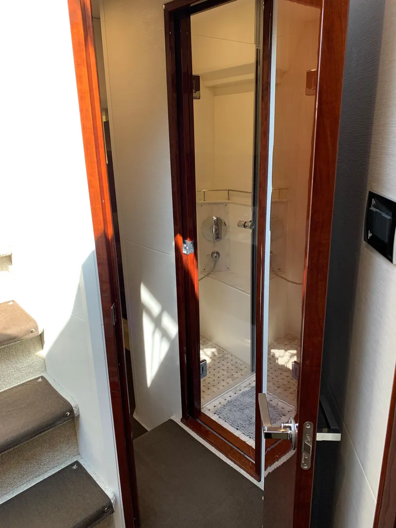 Slide: The Image of 2017 Sea Ray Sundancer 460 yacht interior bathroom with glass door and wooden frame. - 43