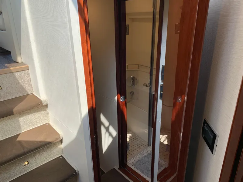 Slide: The Image of 2017 Sea Ray Sundancer 460 interior stairs and bathroom door. - 44