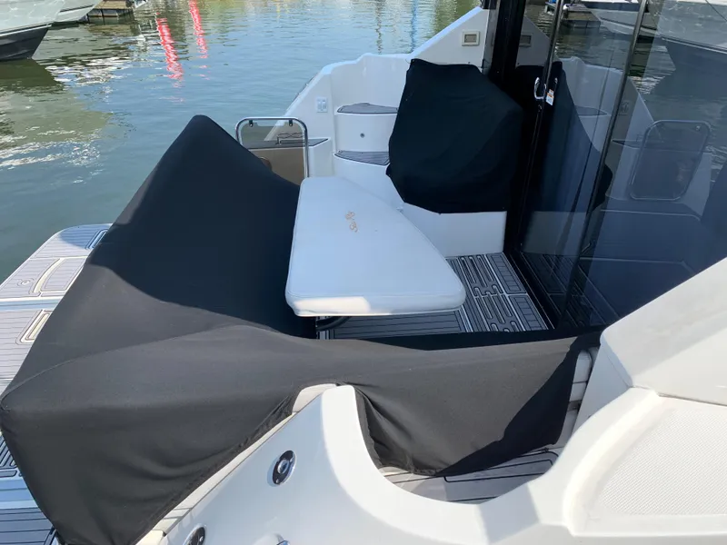 Slide: The Image of 2017 Sea Ray Sundancer 460 yacht deck with covered seating and table. - 8