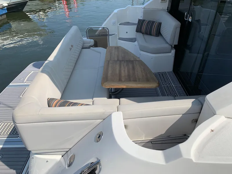 Slide: The Image of 2017 Sea Ray Sundancer 460 yacht with spacious outdoor seating and wooden table. - 9