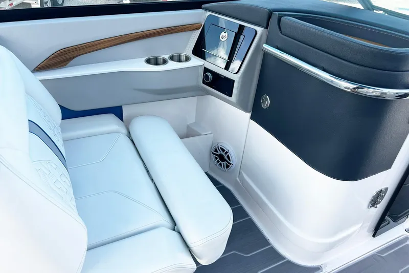 Slide: The Image of 2024 Regal LS9 boat interior with white seating, wood accents, and modern dashboard. - 11