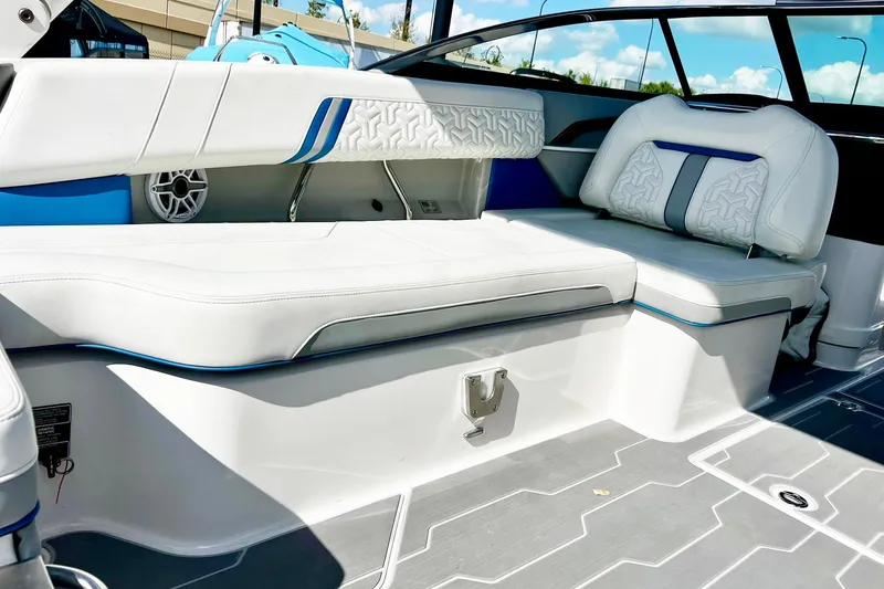 Slide: The Image of 2024 Regal LS9 boat interior with white and blue seating, modern design, and stylish upholstery. - 14