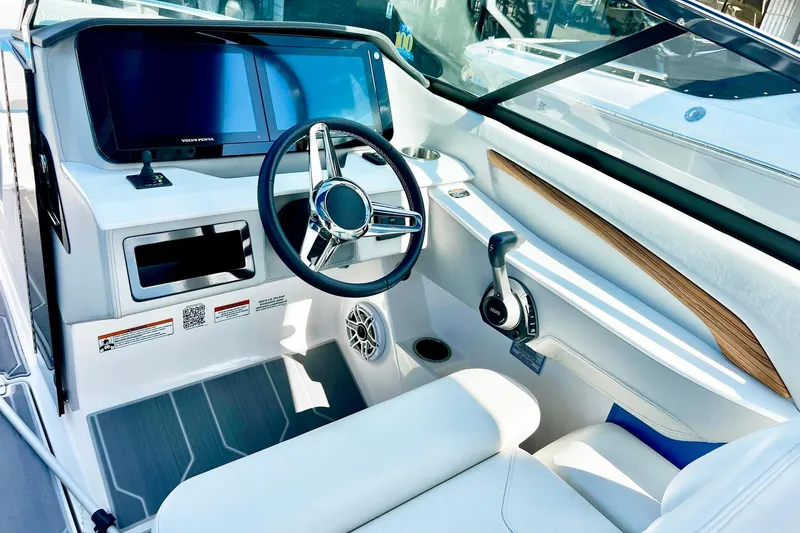 Slide: The Image of 2024 Regal LS9 boat cockpit with modern steering wheel, touchscreen display, and sleek interior design. - 15