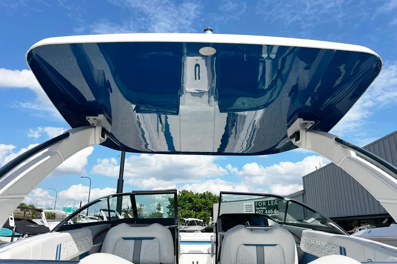 Slide: The Image of 2024 Regal LS9 boat with sleek design and spacious seating under a clear blue sky. - 9