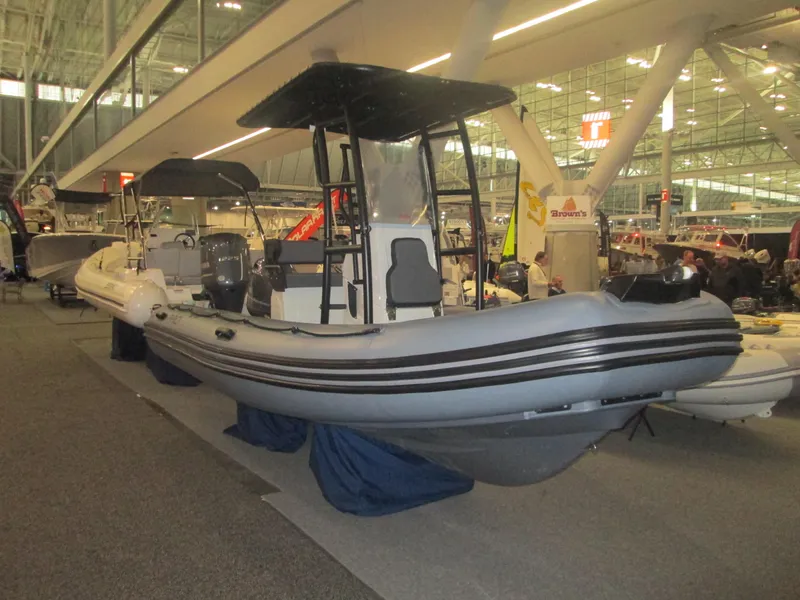 Slide: The Image of 2024 Zodiac Pro 5.5 inflatable boat displayed at an indoor boat show. - 1