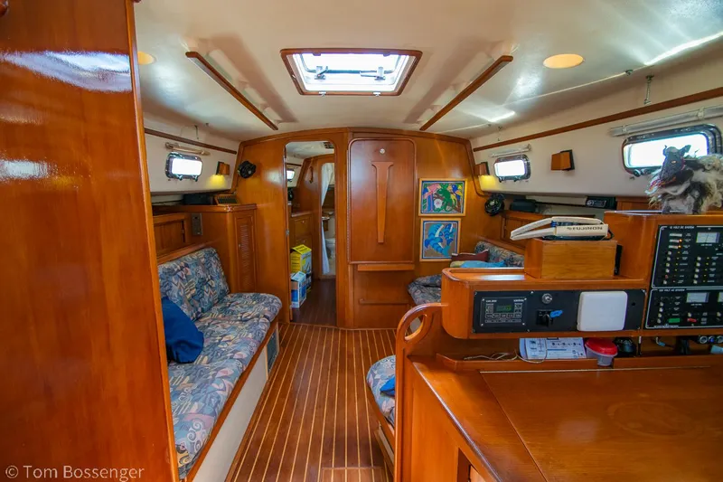 Slide: The Image of Interior of 1997 Island Packet 45 sailboat with wood finish and cozy seating area. - 10