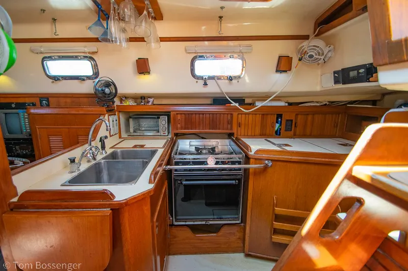 Slide: The Image of Interior of 1997 Island Packet 45 yacht kitchen with wood cabinetry and modern appliances. - 12