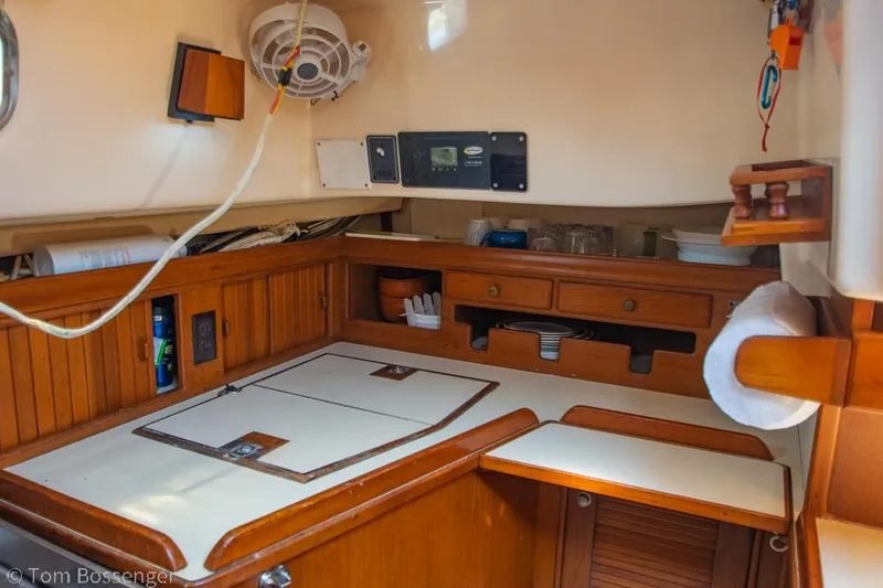 Slide: The Image of 1997 Island Packet 45 yacht interior with wooden cabinetry and navigation equipment. - 14