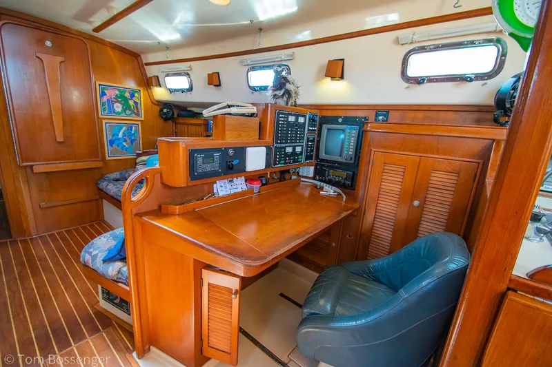 Slide: The Image of Navigation station inside 1997 Island Packet 45 sailboat with wooden interior and equipment. - 15
