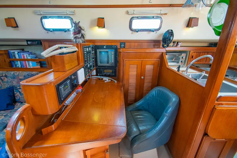 Slide: The Image of Interior of 1997 Island Packet 45 yacht with navigation station and seating. - 16