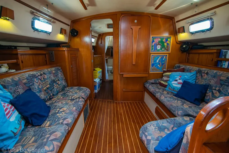 Slide: The Image of Interior of a 1997 Island Packet 45 sailboat with cozy seating and wooden finishes. - 18