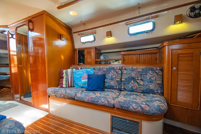 Slide: The Image of Interior of 1997 Island Packet 45 sailboat with cozy seating and wooden cabinetry. - 21