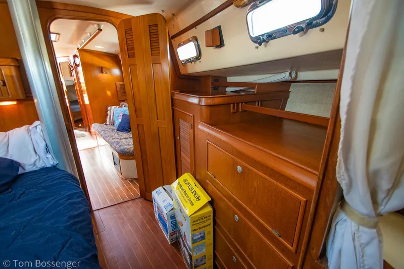 Slide: The Image of Interior of 1997 Island Packet 45 sailboat with wooden cabinetry and cozy seating area. - 26