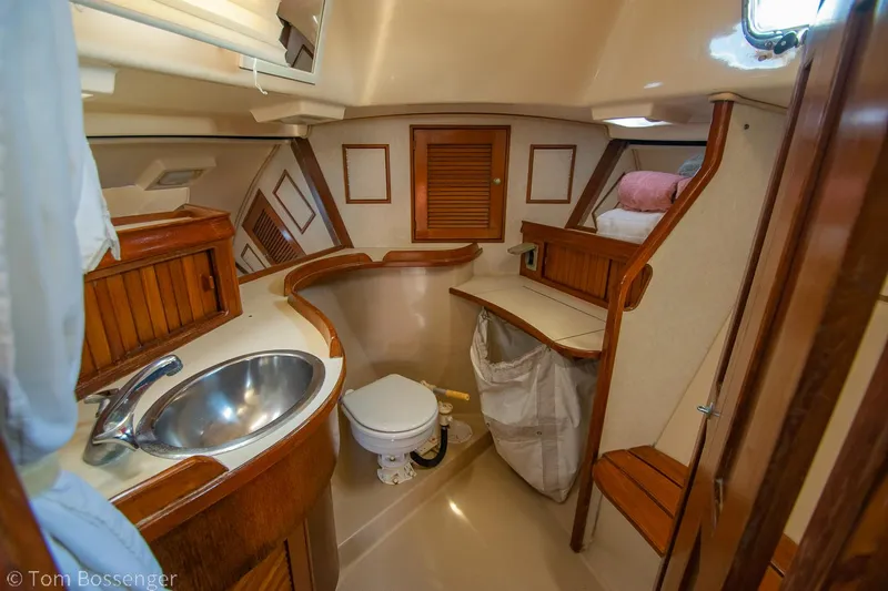 Slide: The Image of 1997 Island Packet 45 yacht interior with wooden cabinetry and compact bathroom. - 27