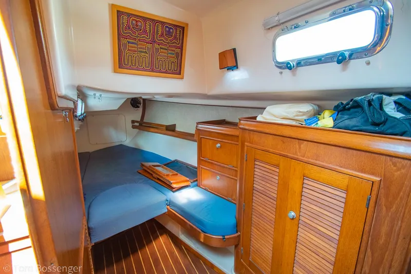 Slide: The Image of Cozy cabin interior of a 1997 Island Packet 45 sailboat with wooden furnishings. - 28