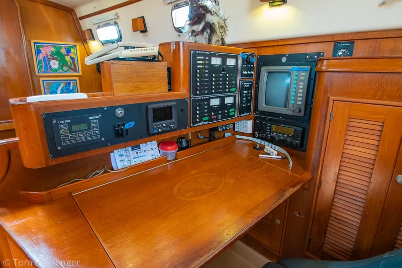 Slide: The Image of Navigation station on a 1997 Island Packet 45 sailboat with control panels and equipment. - 31