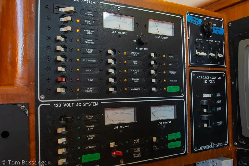 Slide: The Image of Electrical control panel on a 1997 Island Packet 45 sailboat, featuring AC and DC systems. - 33