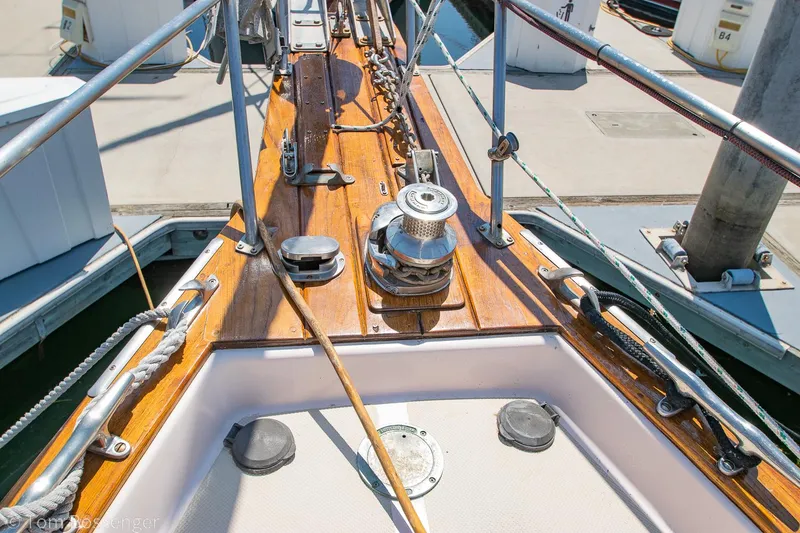 Slide: The Image of Deck view of a 1997 Island Packet 45 sailboat, featuring polished wood and metal fittings. - 46