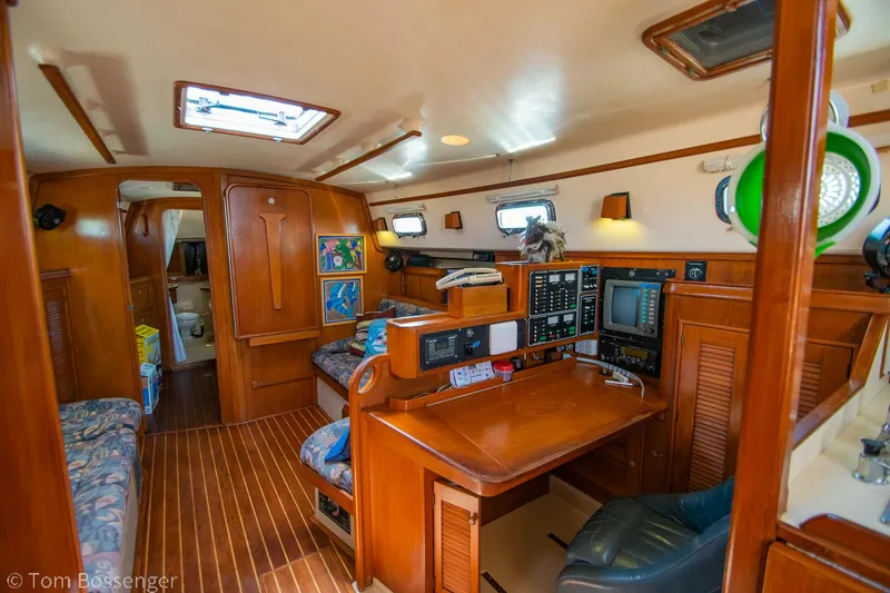 Slide: The Image of Interior of 1997 Island Packet 45 sailboat with navigation station and wooden finishes. - 8