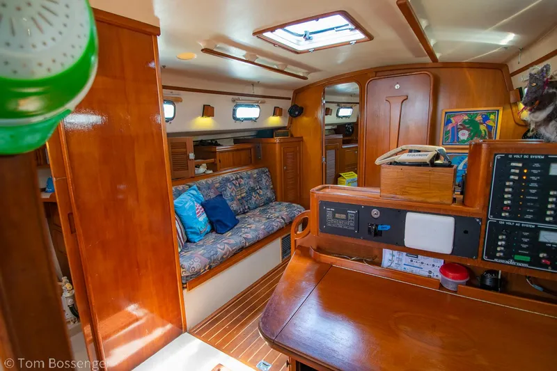 Slide: The Image of Interior of 1997 Island Packet 45 sailboat with wood finish and cozy seating area. - 9