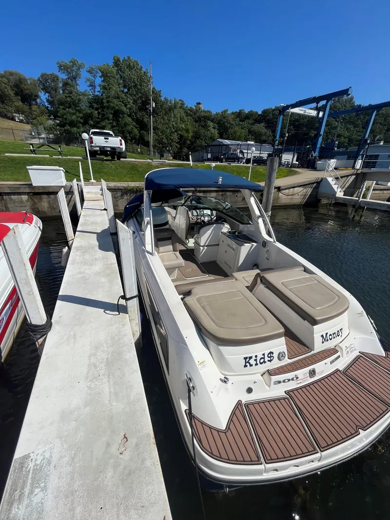 Slide: The Image of 2013 Sea Ray 300 SLX boat docked at a marina on a sunny day. - 14