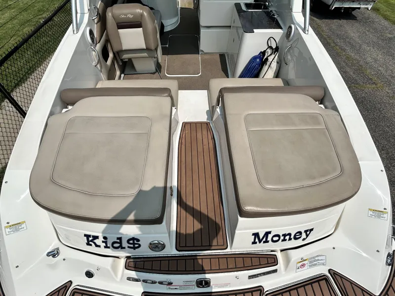 Slide: The Image of 2013 Sea Ray 300 SLX boat interior with Kids and Money labels on seats. - 15